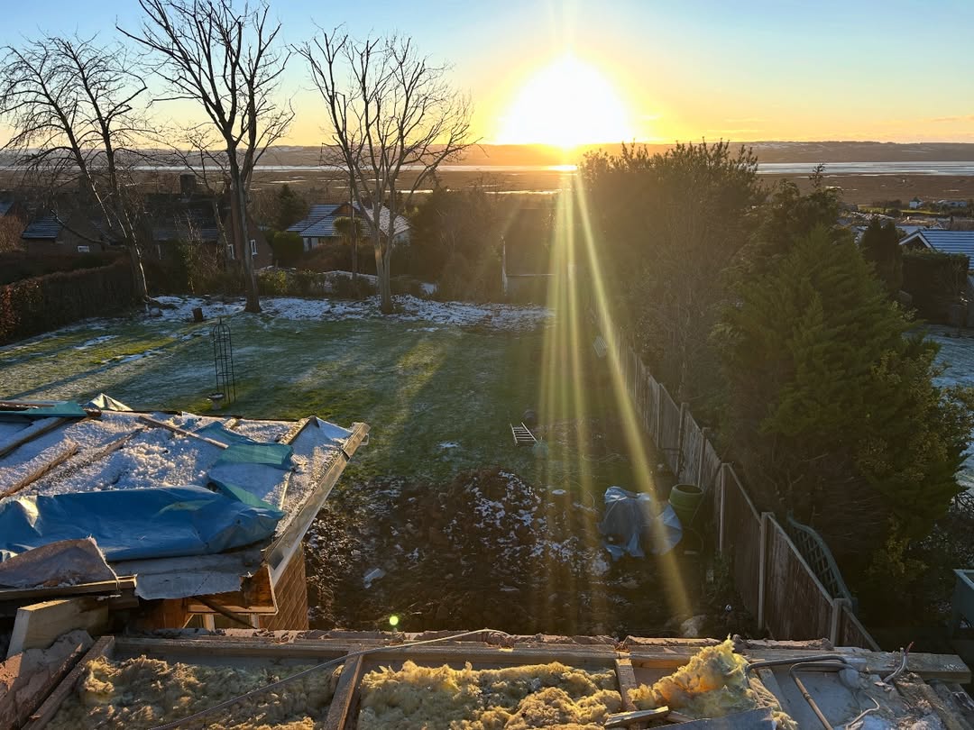Rooftop view over the Dee Estuary at sunrise during roof rebuild, Wirral