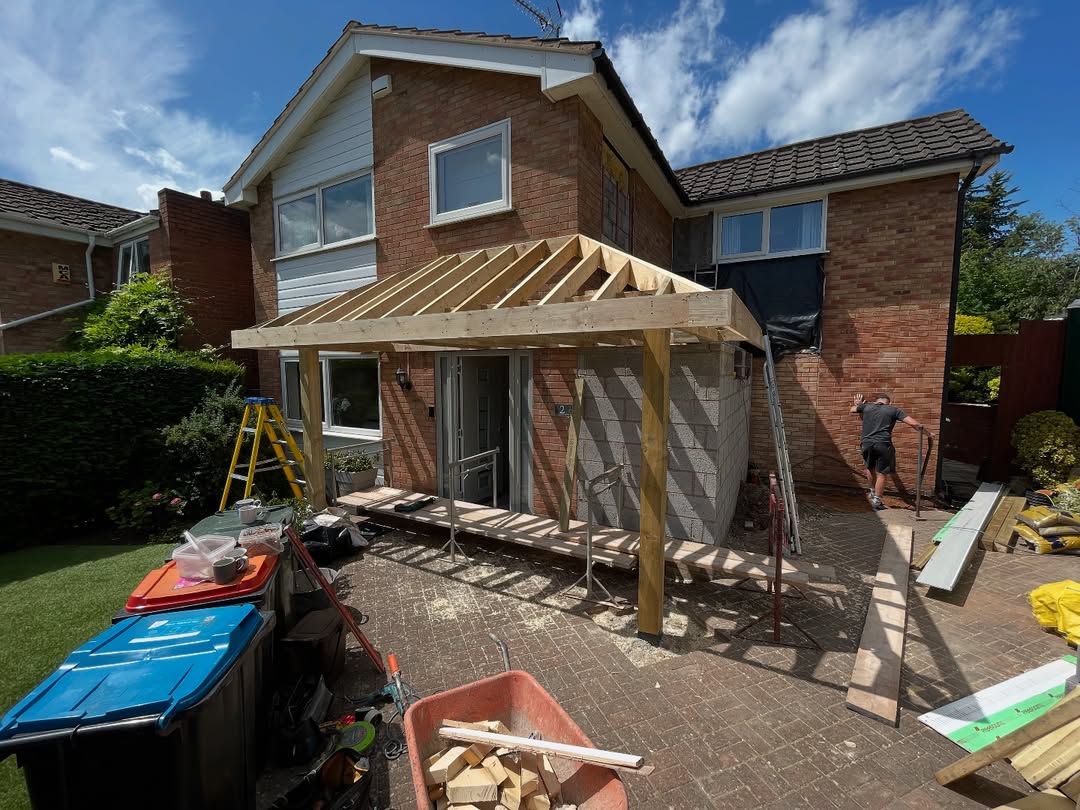 Rear extension under construction with timber lean-to roof frame, Wirral